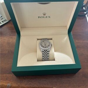 Rolex Silver Timepiece with Cream Dial